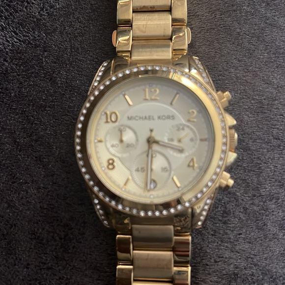 Gold and diamond Michael Kors large gold watch.